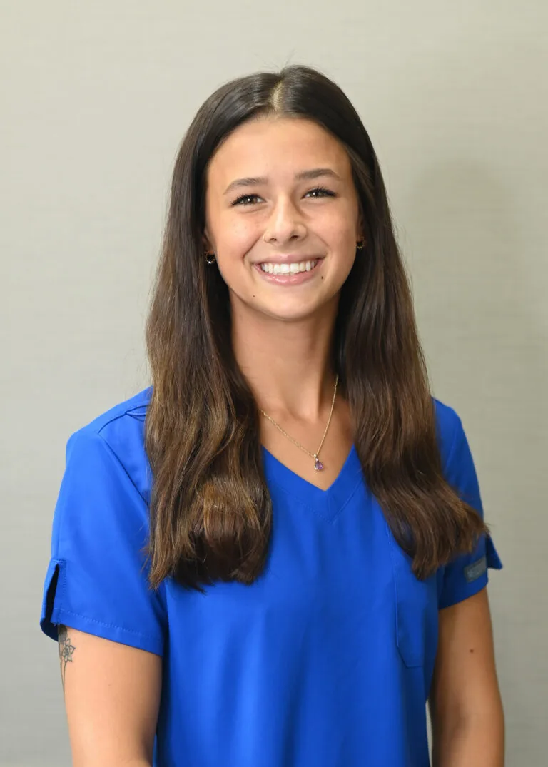 Headshot of Emma Snyder wearing a blue scrubs against a plain white background.