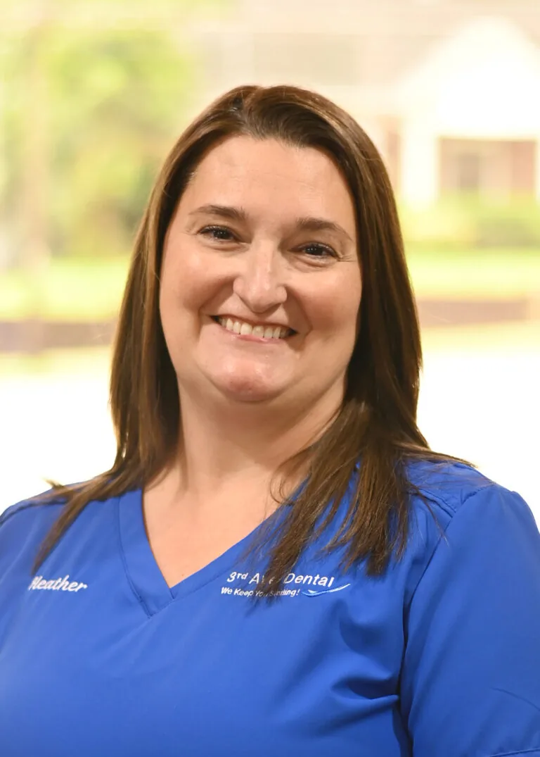 Headshot of Heather Cline wearing a blue scrubs against a plain white background.