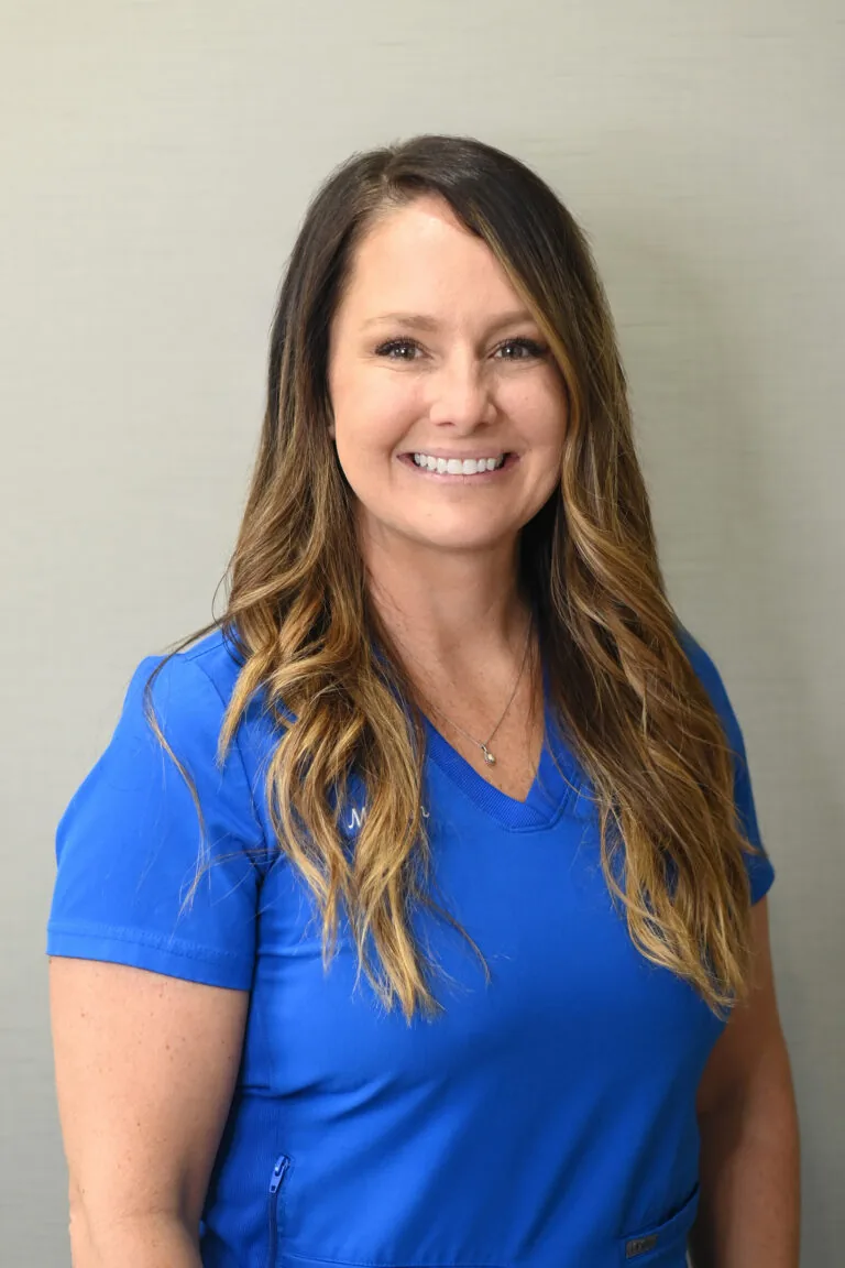 Headshot of Meleah Hunsucker wearing a blue scrubs against a plain white background.