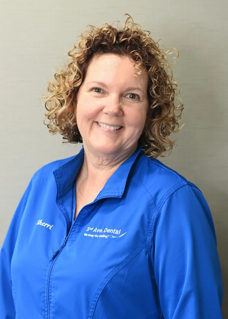 Headshot of Sherri Moore wearing a blue scrubs against a plain white background.