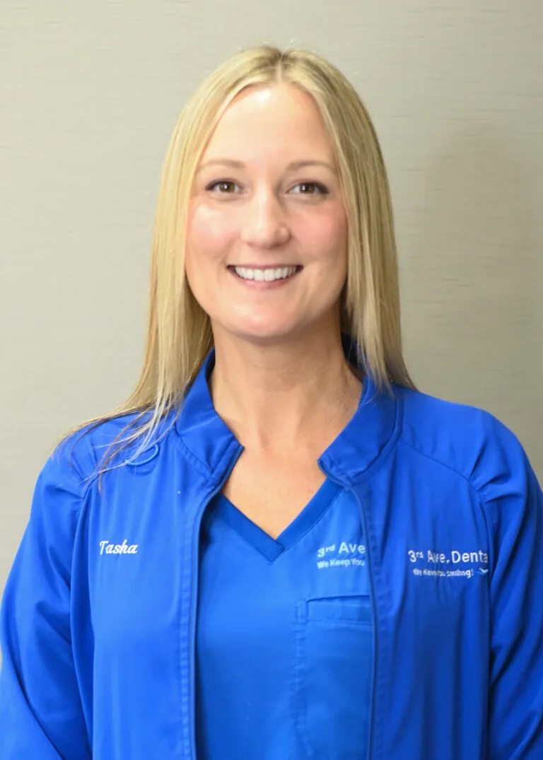 Headshot of Tasha Suddreth wearing a blue scrubs against a plain white background.
