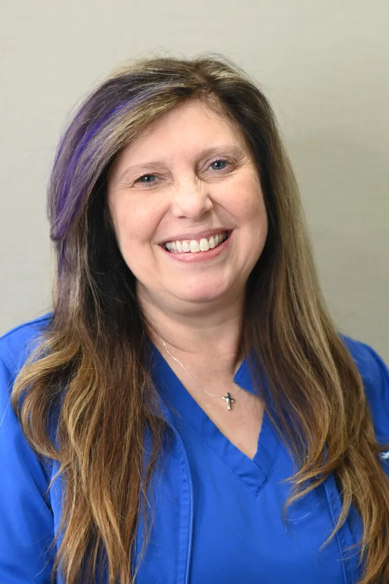 Headshot of Tracy Bumgarner wearing a blue scrubs against a plain white background.